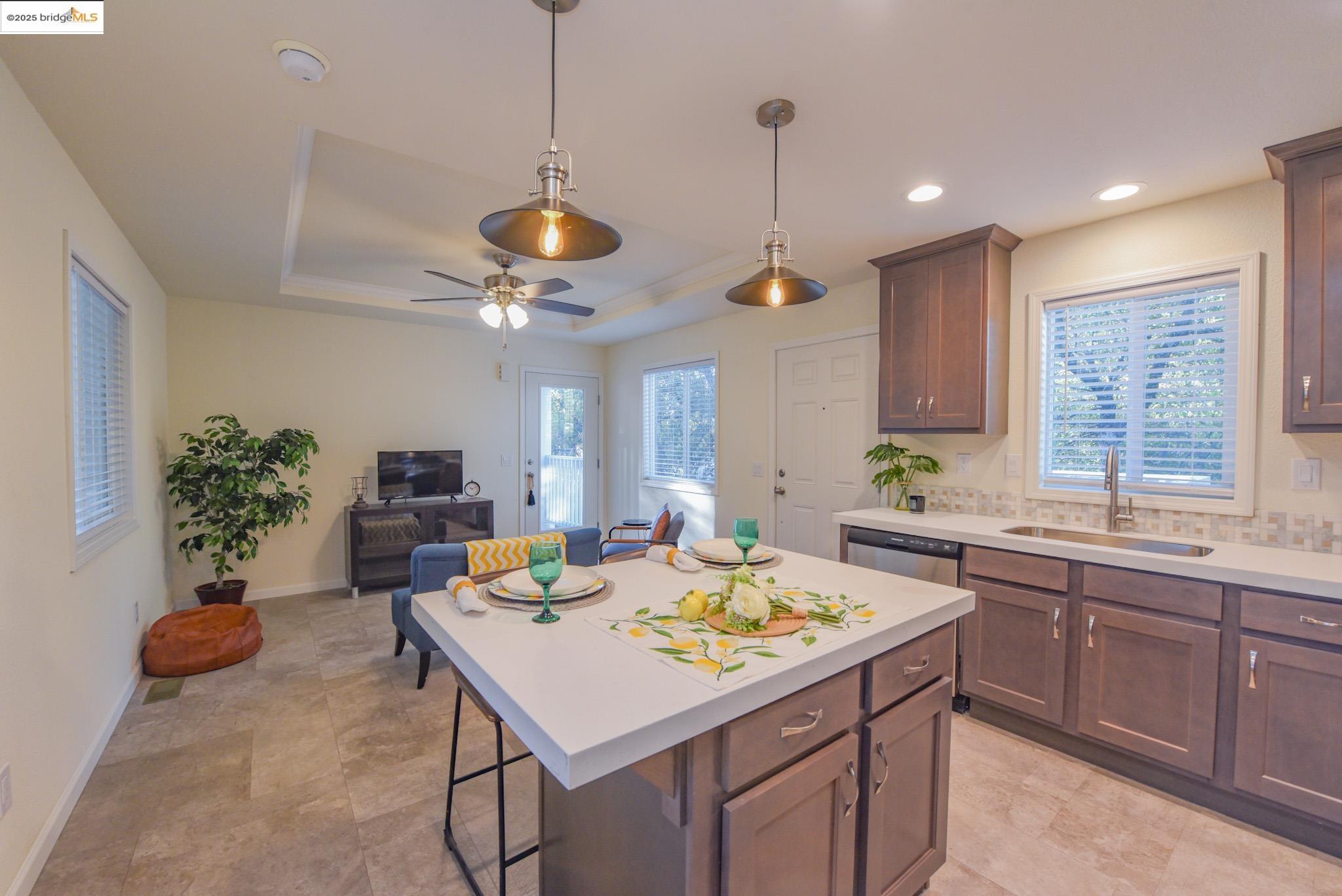 10956 Green Street Columbia, CA 95310 - Photo 44 of 45 Kitchen with decorative light fixtures, a breakfast bar area, a kitchen island, open floor plan, and plenty of natural light