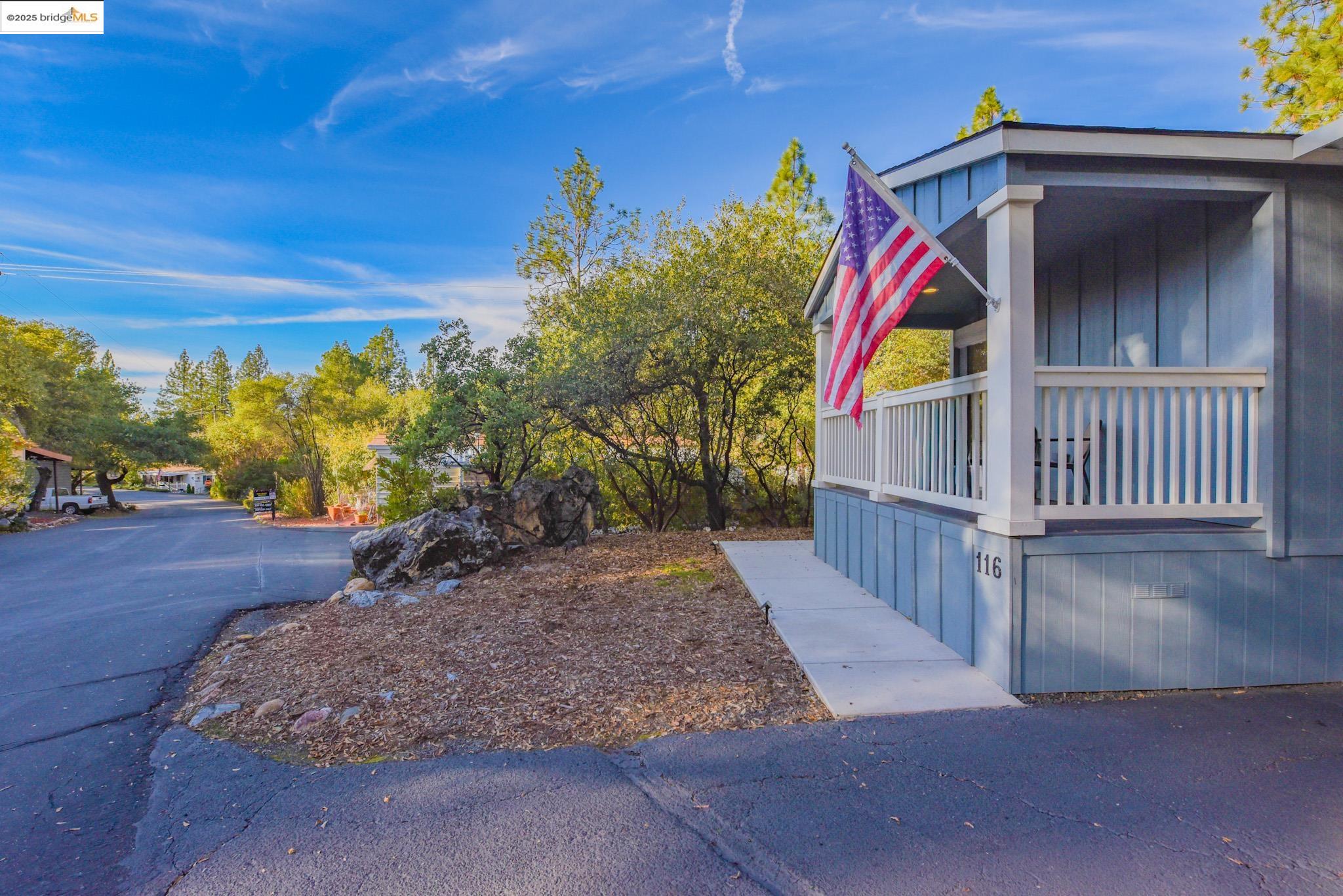 10956 Green Street Columbia, CA 95310 - Photo 38 of 45 View of side of property with board and batten siding and a porch