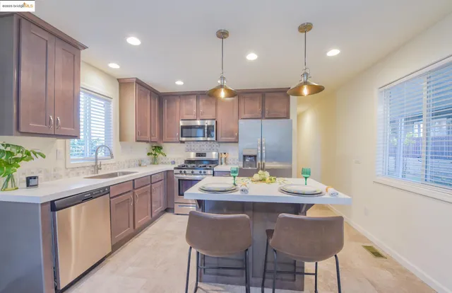 a large kitchen with a table and chairs in it