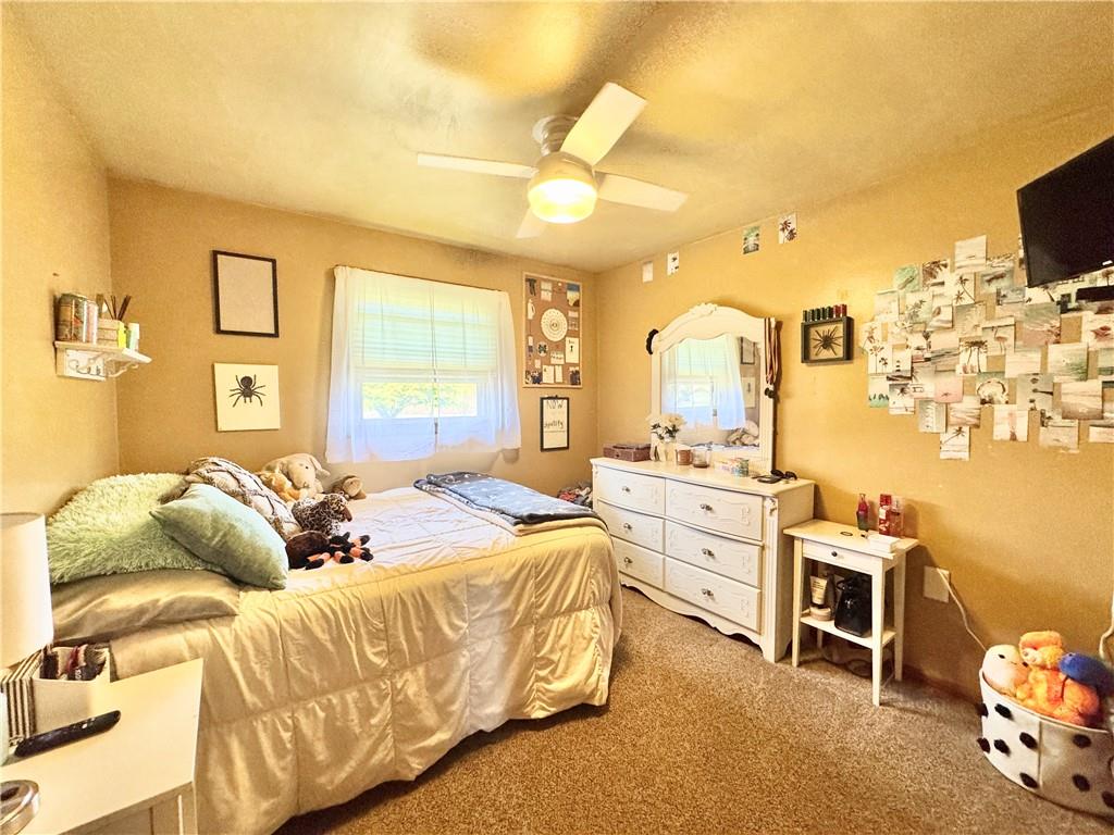 824 Shenango Road New Castle, PA 16101 - Photo 18 of 34 a bedroom with a bed and a chandelier