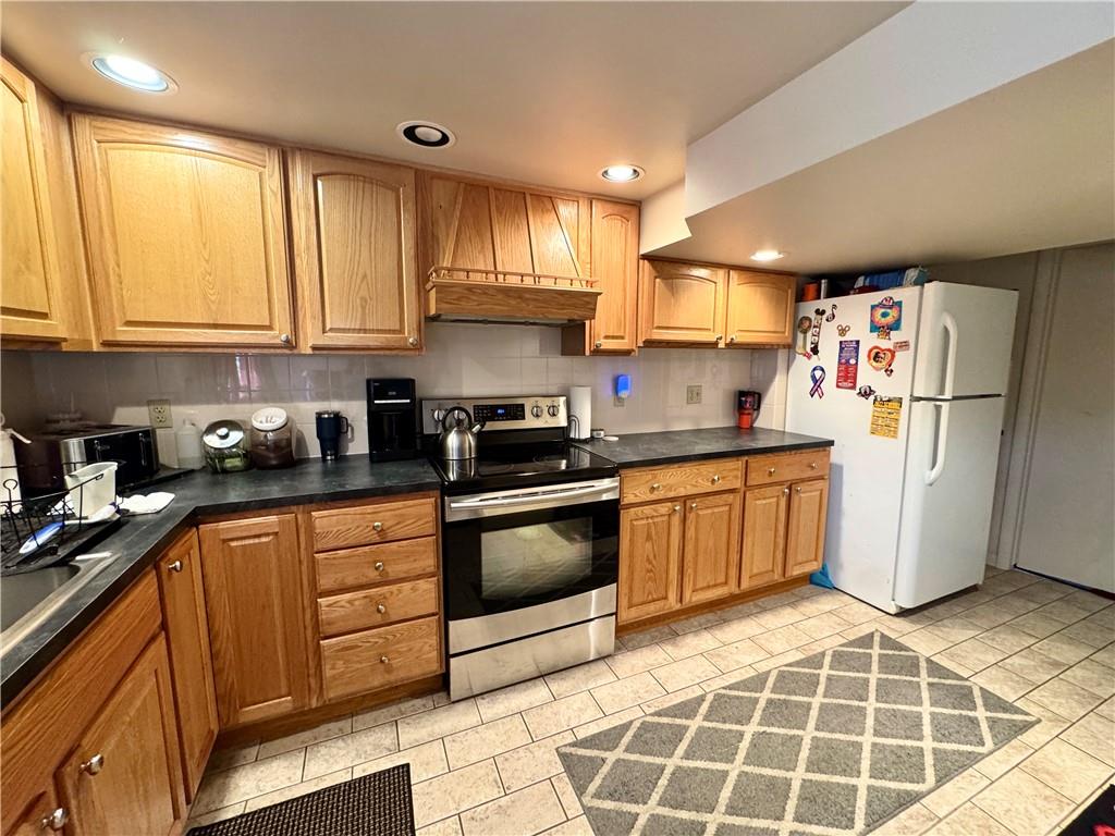 824 Shenango Road New Castle, PA 16101 - Photo 27 of 34 a kitchen with a sink a refrigerator and cabinets
