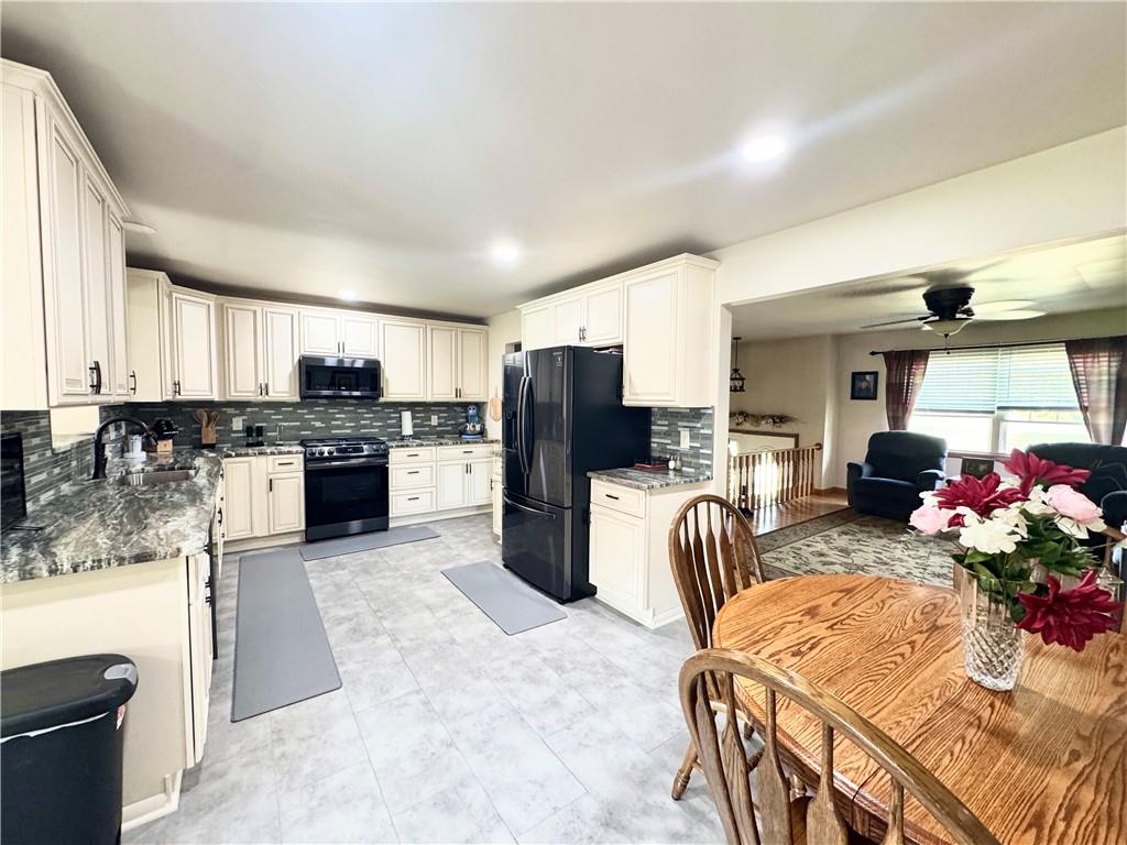 824 Shenango Road New Castle, PA 16101 - Photo 7 of 34 a kitchen with stainless steel appliances granite countertop a refrigerator sink stove microwave and cabinets