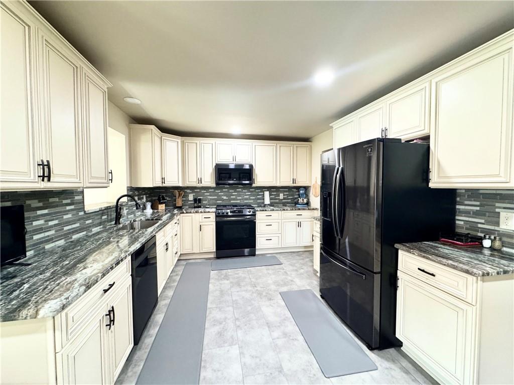 824 Shenango Road New Castle, PA 16101 - Photo 9 of 34 a kitchen with a refrigerator a sink dishwasher and a stove top oven with wooden floor