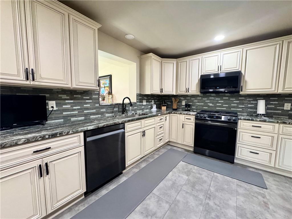 824 Shenango Road New Castle, PA 16101 - Photo 10 of 34 a white kitchen with granite countertop white cabinets and white stainless steel appliances