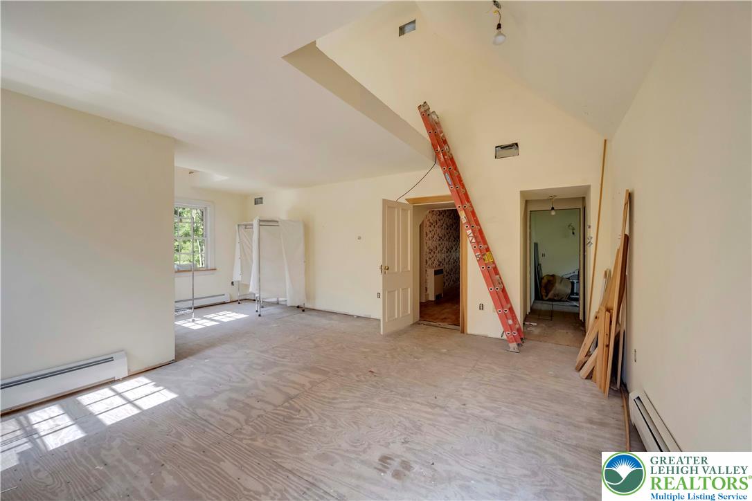 384 Henry Road Nazareth, PA 18064 - Photo 46 of 54 An upper-level room under construction showcases high vaulted ceilings and subfloor ready for customization.