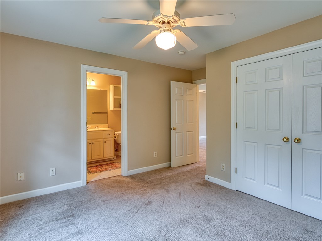 7914 O Neil Road Gloucester, VA 23061 - Photo 30 of 47 Unfurnished bedroom with light colored carpet, ceiling fan, a closet, and ensuite bath