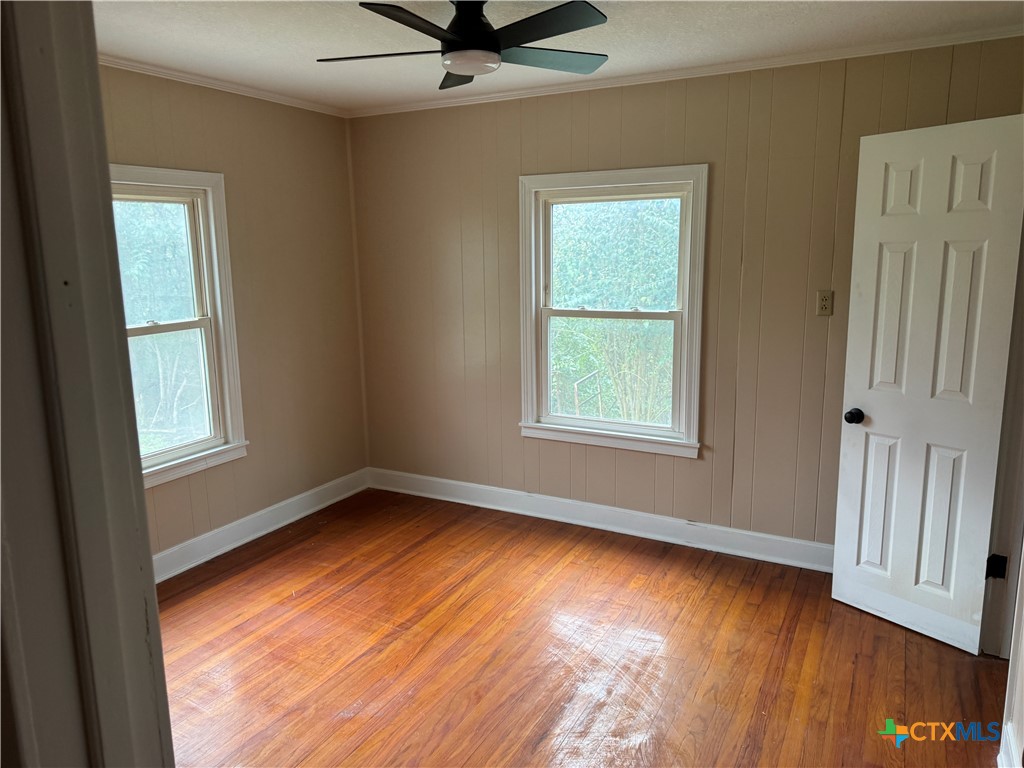 3510 Gun Club Road Temple, TX 76501 - Photo 14 of 17 a view of an empty room with wooden floor and a window