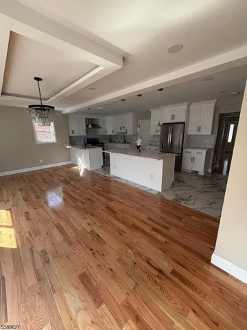 a large white kitchen with a stove a refrigerator and a sink