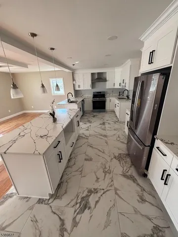 a view of empty room with wooden floor and stairs