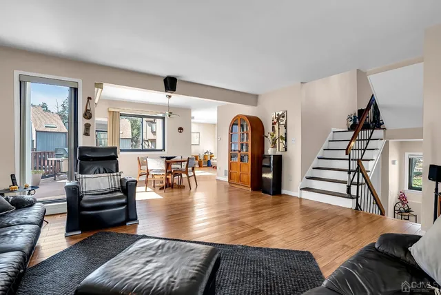 a view of a livingroom with furniture window and wooden floor