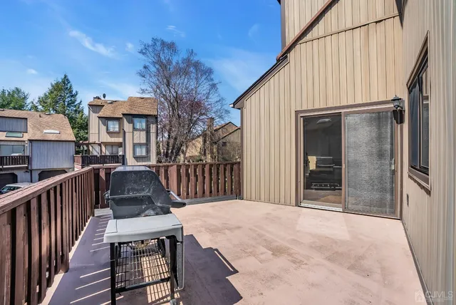 a view of a backyard with a bench and wooden fence
