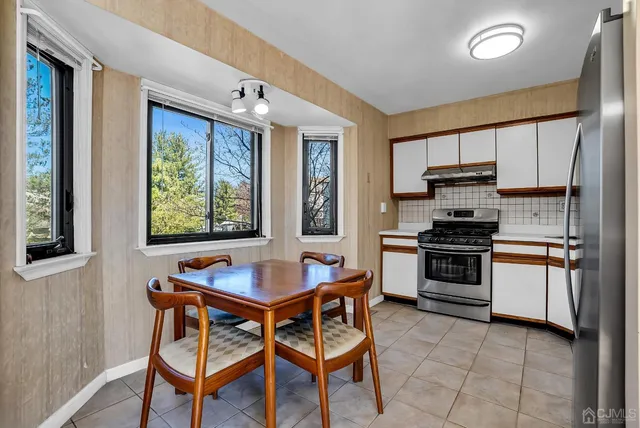 a kitchen with stainless steel appliances granite countertop a refrigerator stove top oven and sink