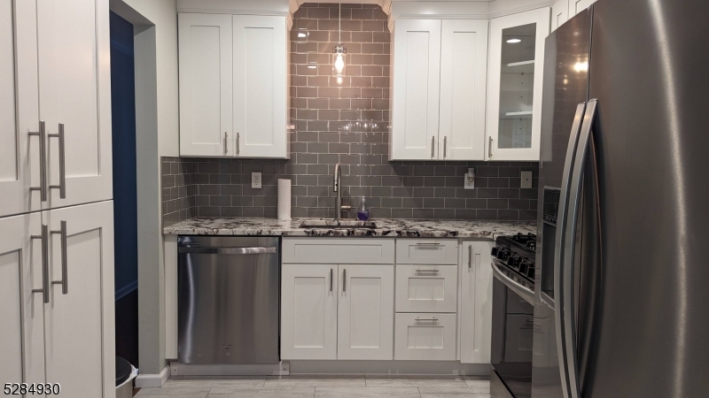 16 Cellar Avenue, Unit 16 Clark, NJ 07066 - Photo 4 of 12 a kitchen with stainless steel appliances granite countertop a stove a refrigerator and a sink