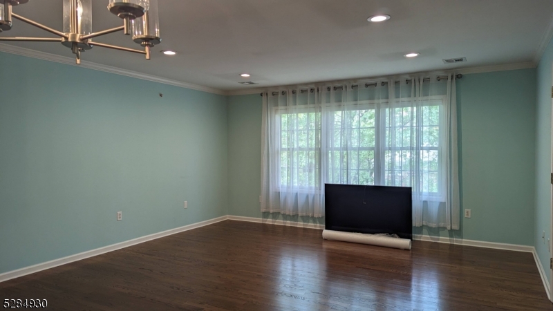 16 Cellar Avenue, Unit 16 Clark, NJ 07066 - Photo 6 of 12 an empty room with wooden floor and windows