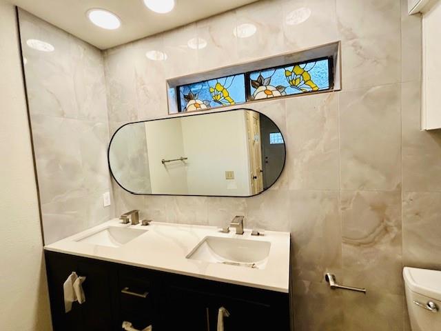 17119 Upper Bay Road Addison, TX 75001 - Photo 19 of 29 a bathroom with a sink mirror and toilet