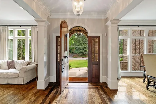 a dining room with furniture a chandelier and window