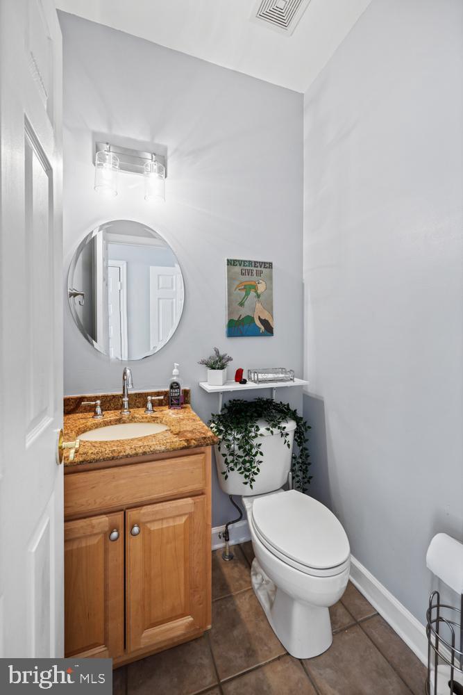 13710 Baden Naylor Road Upper Marlboro, MD 20772 - Photo 22 of 66 a bathroom with a granite countertop toilet sink and mirror