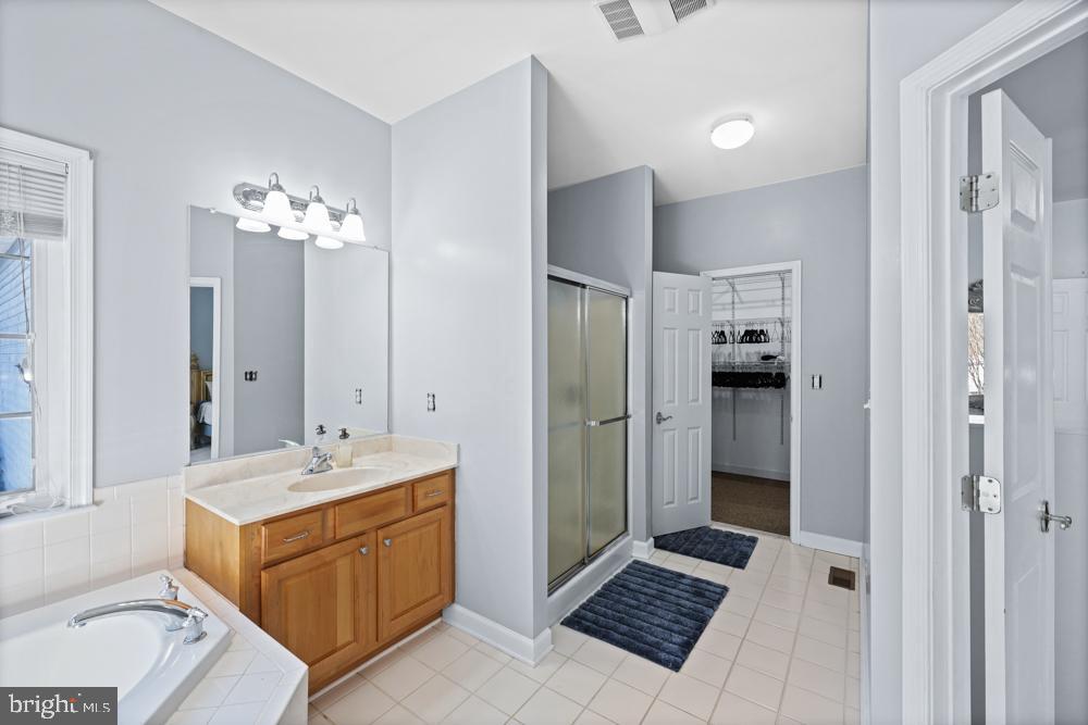 13710 Baden Naylor Road Upper Marlboro, MD 20772 - Photo 28 of 66 a spacious bathroom with a double vanity sink a mirror and a shower