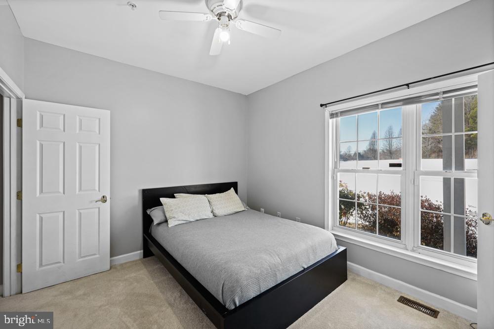 13710 Baden Naylor Road Upper Marlboro, MD 20772 - Photo 35 of 66 a bedroom with a large bed and a window