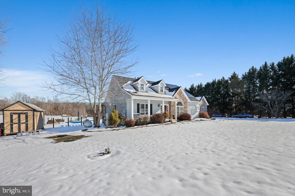 13710 Baden Naylor Road Upper Marlboro, MD 20772 - Photo 4 of 66 a view of a white house with a yard covered in snow