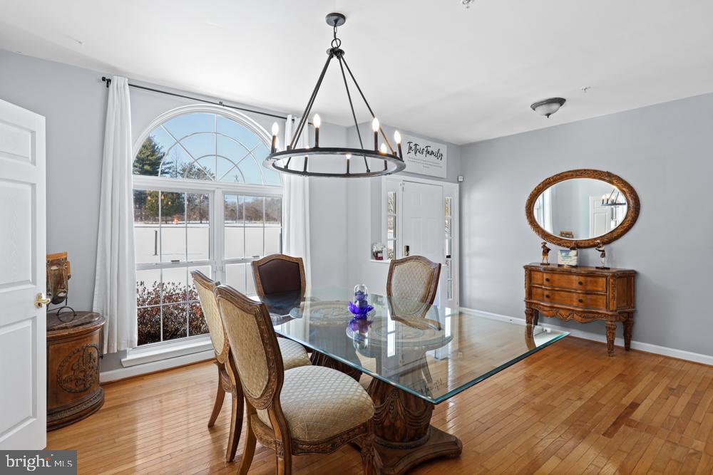 13710 Baden Naylor Road Upper Marlboro, MD 20772 - Photo 6 of 66 a dining room with furniture a chandelier and wooden floor