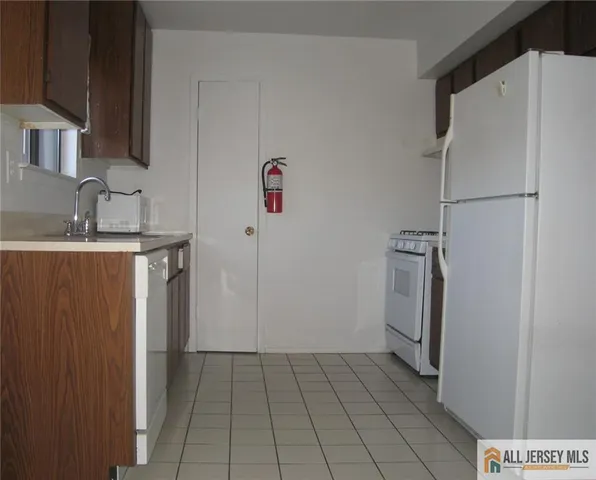 a kitchen with a refrigerator and a sink