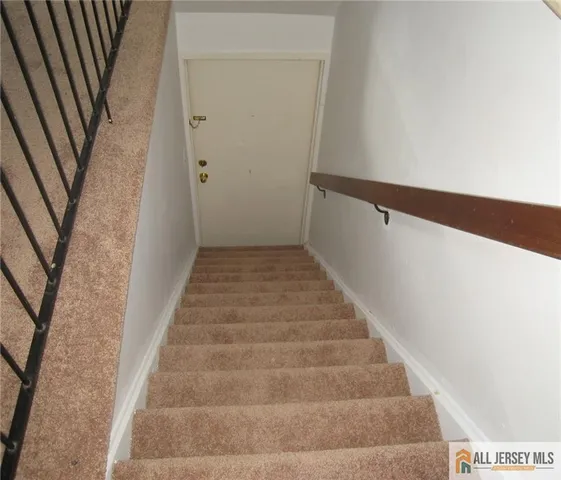 a view of staircase with white walls