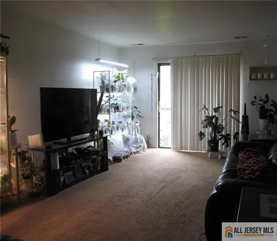 a view of livingroom with furniture and a flat screen tv