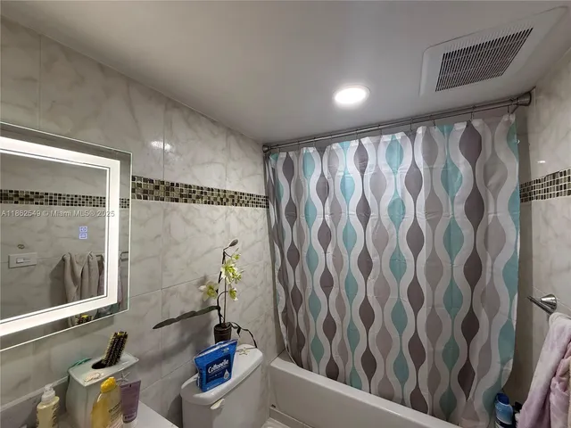 a bathroom with a shower curtain and a sink