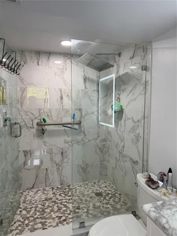 a bathroom with a shower and a toilet