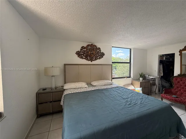 a bedroom with a bed and a television