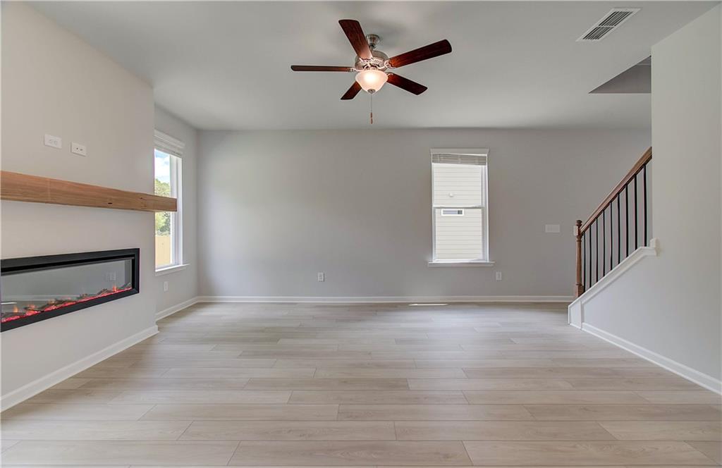 117 Alpine Road Fairburn, GA 30213 - Photo 15 of 29 a view of an empty room with a window and a kitchen