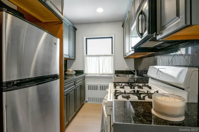 a kitchen with a refrigerator and a stove