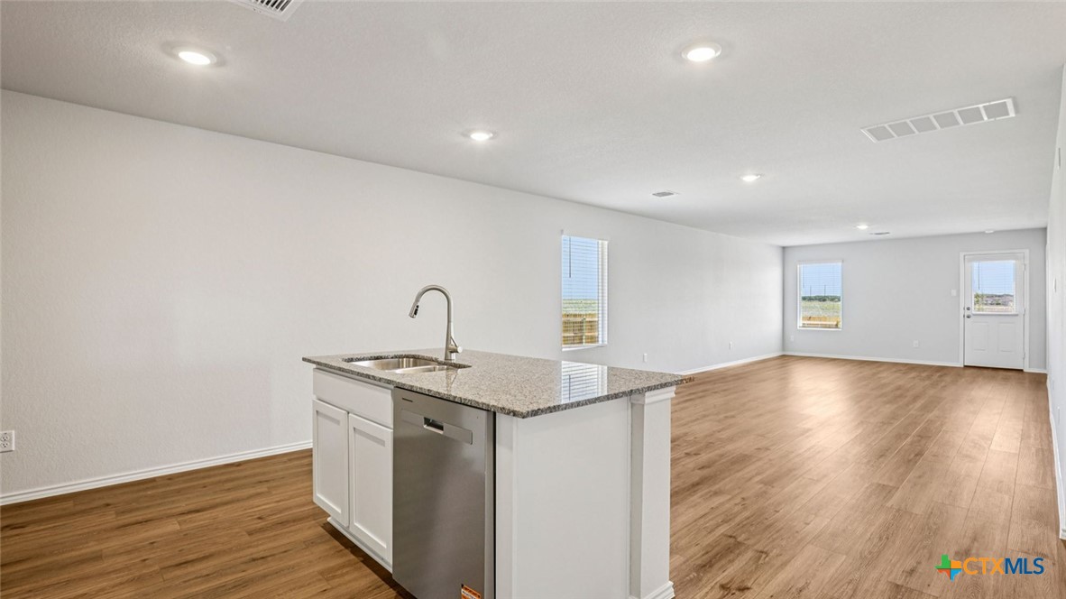 1303 Newey Circle Temple, TX 76504 - Photo 7 of 33 a kitchen with a sink and wooden floor