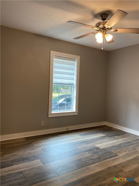 121 Fifteenth Street East Shiner, TX 77984 - Photo 12 of 17 an empty room with wooden floor and windows