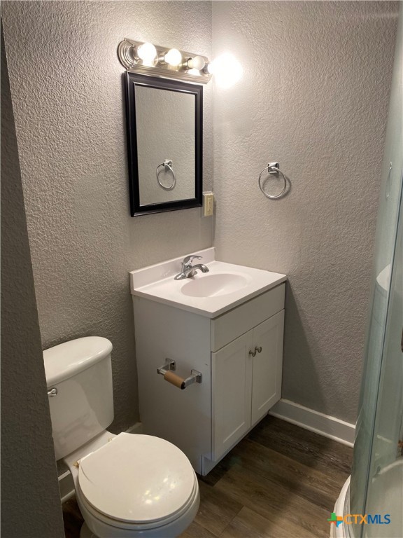 121 Fifteenth Street East Shiner, TX 77984 - Photo 13 of 17 a bathroom with a toilet sink and mirror