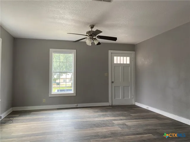 a kitchen with granite countertop a stove a sink and a microwave