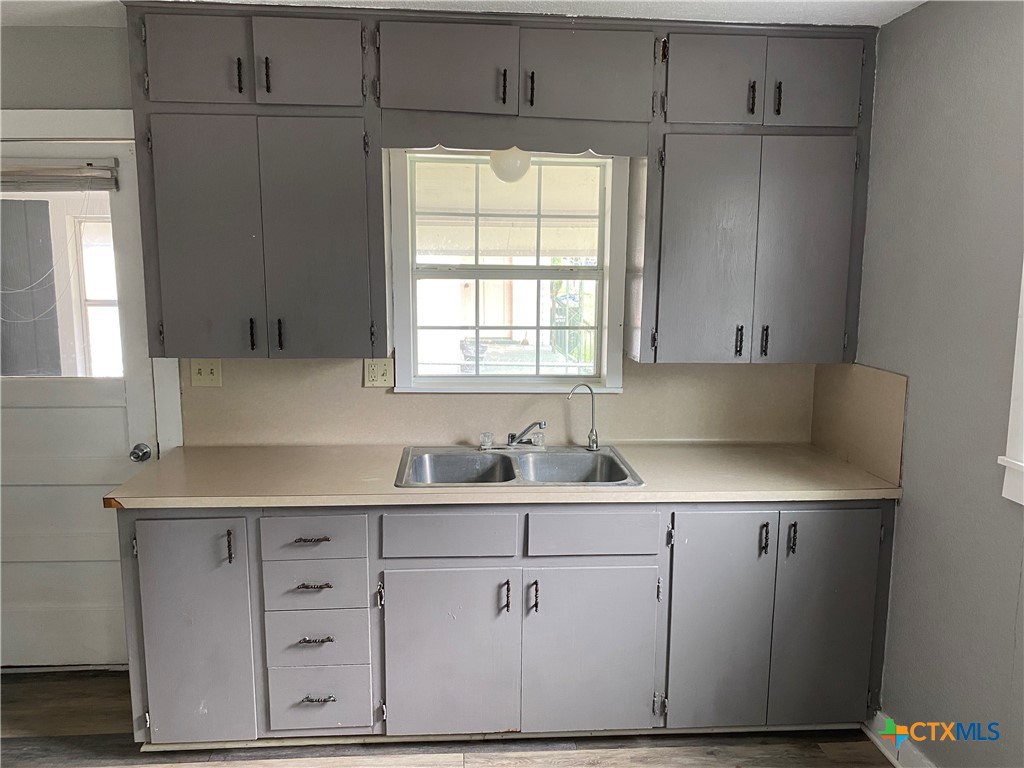 121 Fifteenth Street East Shiner, TX 77984 - Photo 8 of 17 a kitchen with a sink cabinets and window