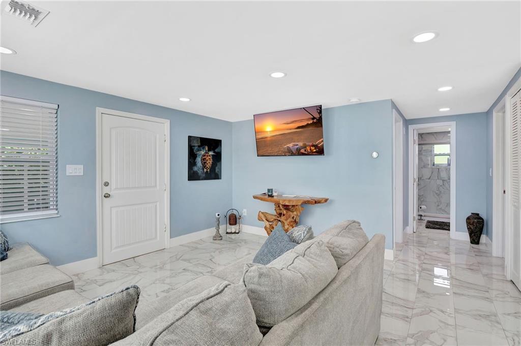1009 Ridge Street Naples, FL 34103 - Photo 27 of 30 Living room with light marble finish floors and recessed lighting
