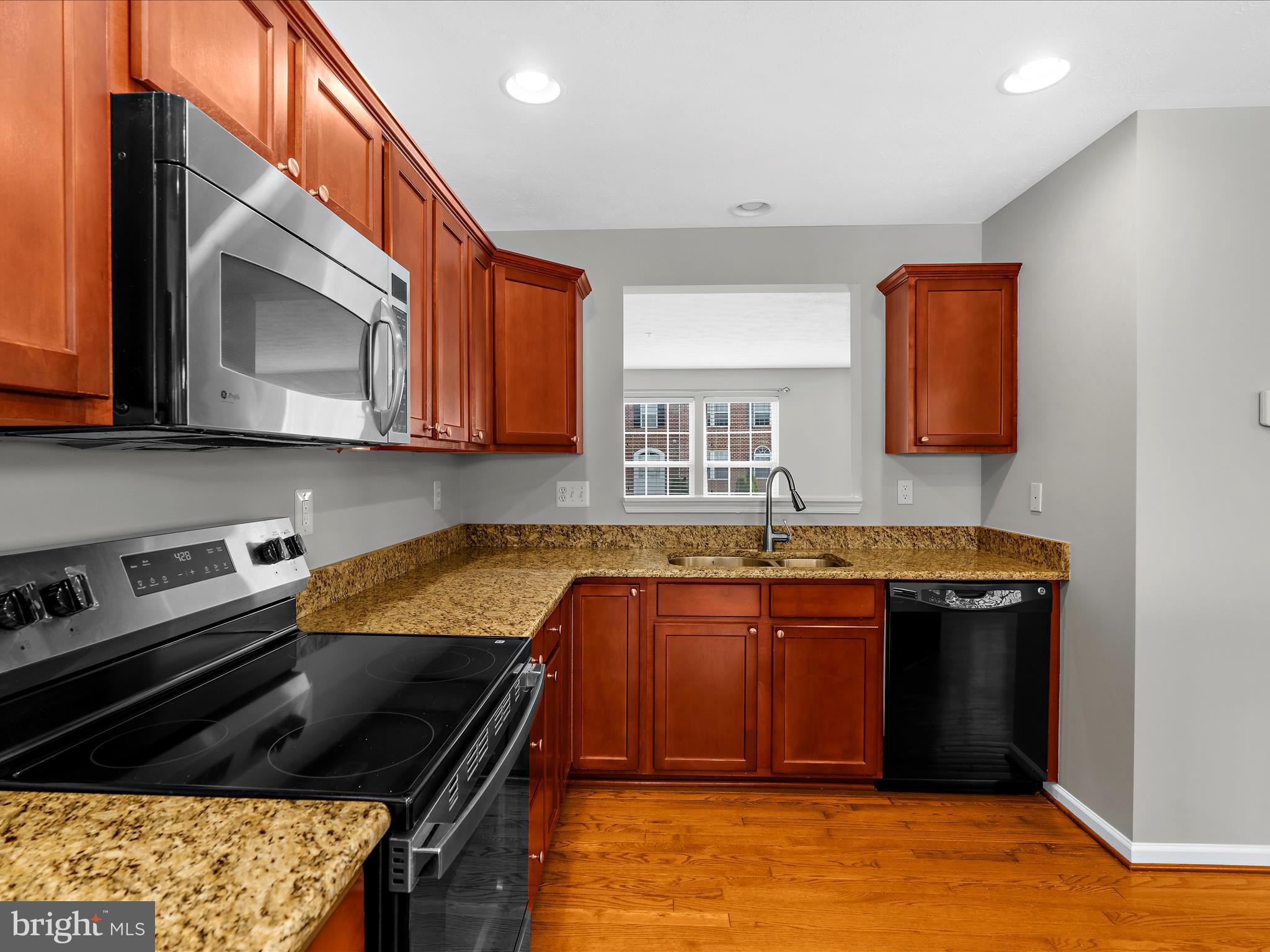 9865 Decatur Road Middle River, MD 21220 - Photo 15 of 63 a kitchen with stainless steel appliances granite countertop a stove a sink and a microwave