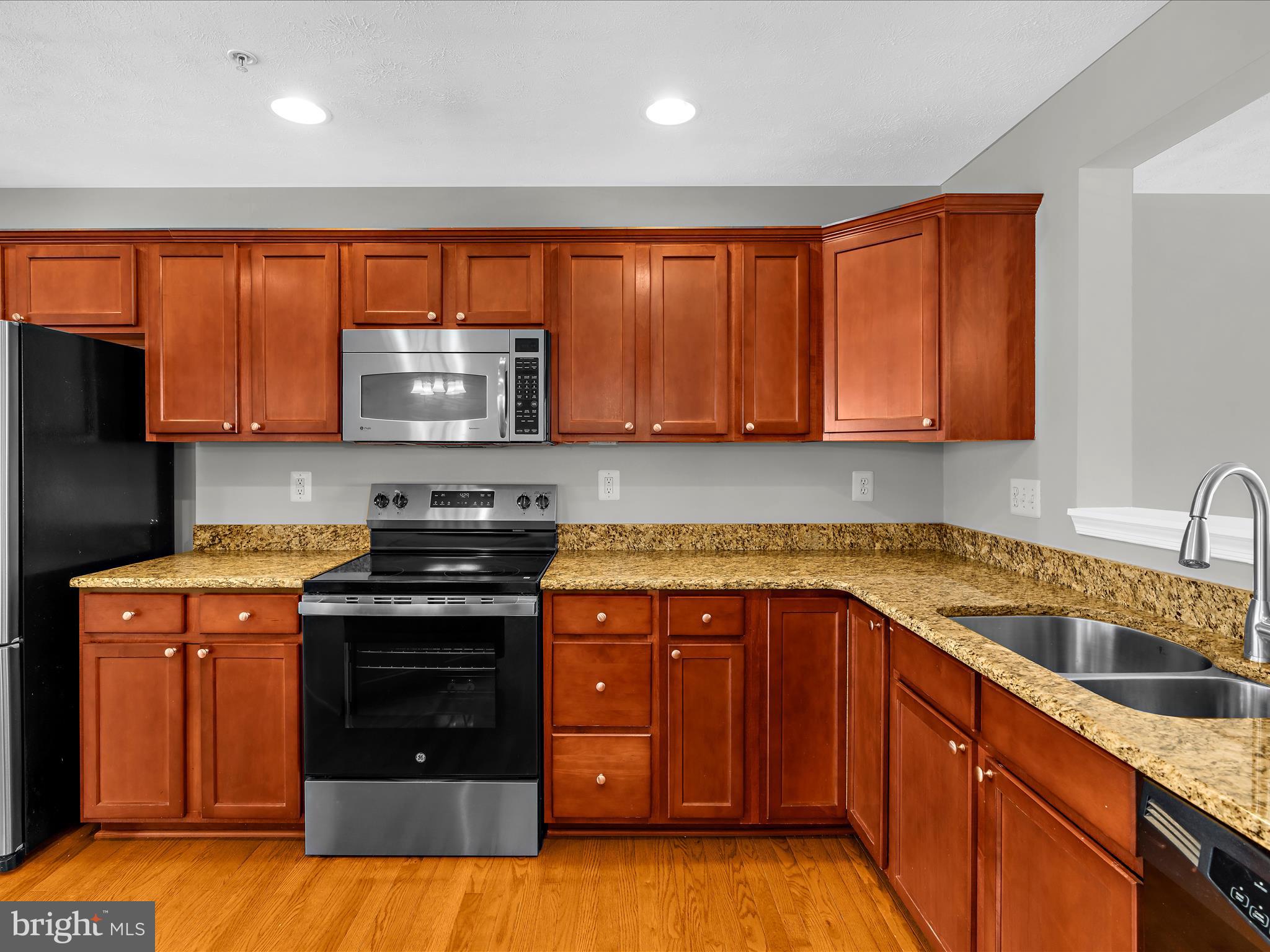 9865 Decatur Road Middle River, MD 21220 - Photo 16 of 63 a kitchen with stainless steel appliances granite countertop a stove a sink and a microwave