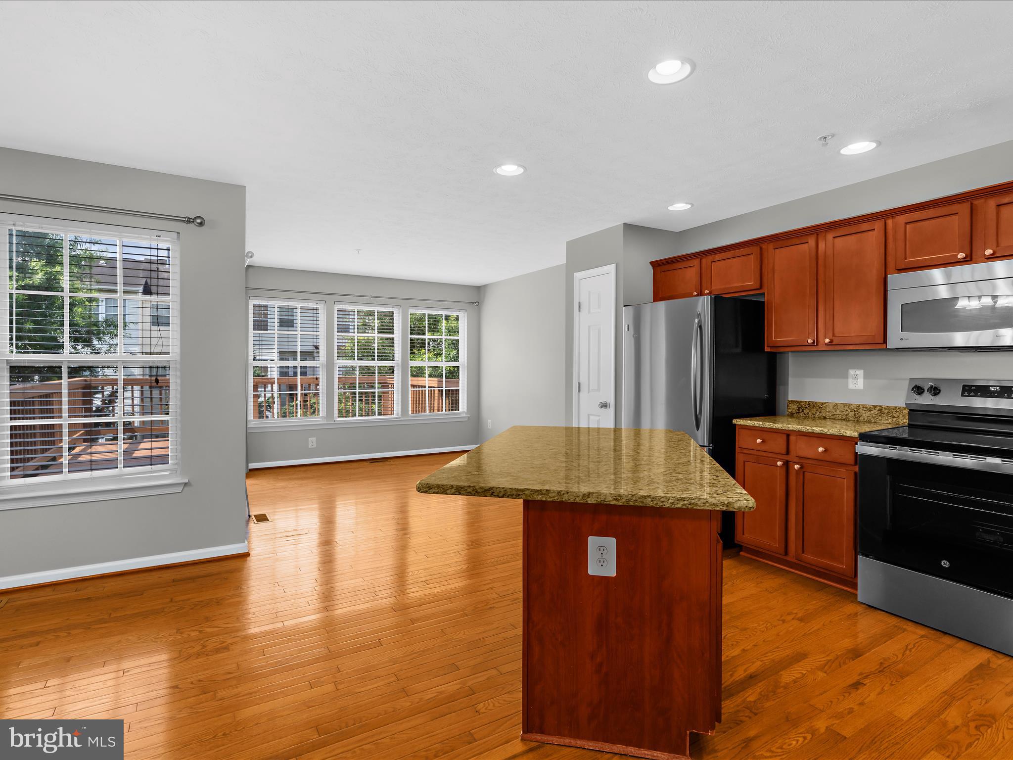 9865 Decatur Road Middle River, MD 21220 - Photo 17 of 63 a kitchen with stainless steel appliances granite countertop a stove and a refrigerator