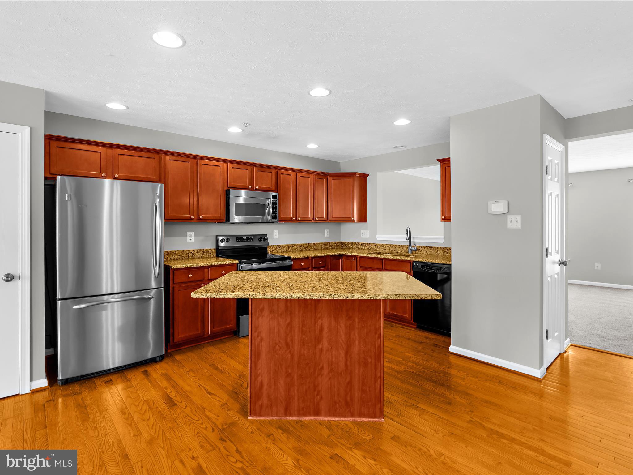 9865 Decatur Road Middle River, MD 21220 - Photo 18 of 63 a large kitchen with stainless steel appliances granite countertop a refrigerator a sink and a stove
