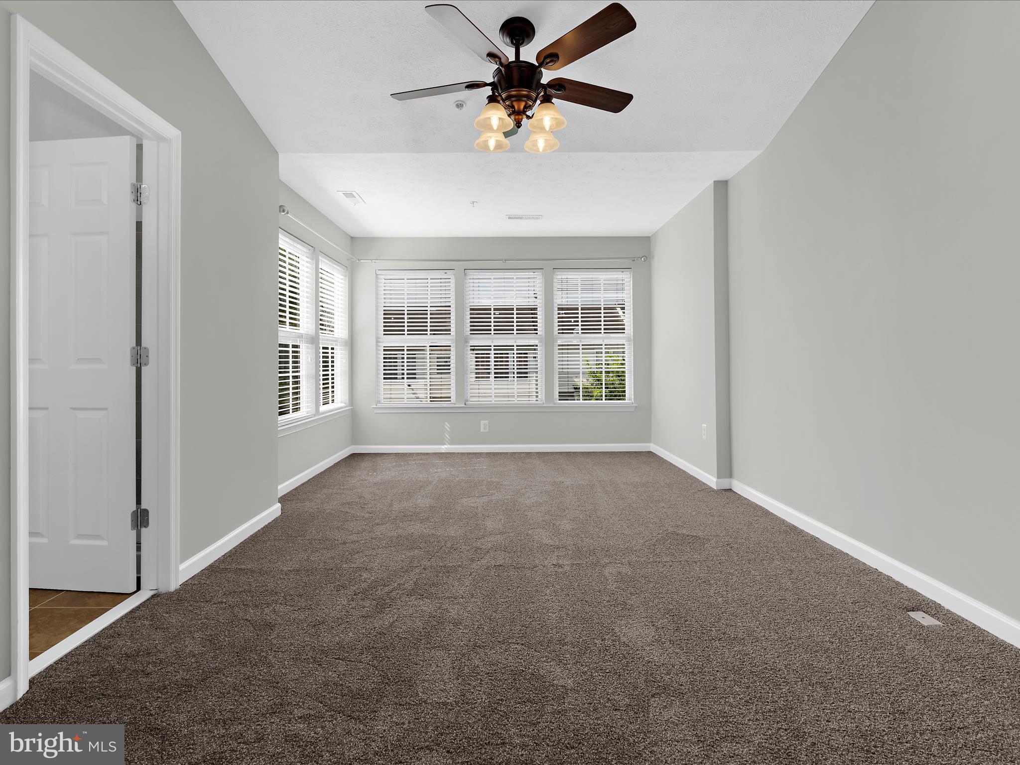 9865 Decatur Road Middle River, MD 21220 - Photo 29 of 63 a view of a livingroom with a ceiling fan and window
