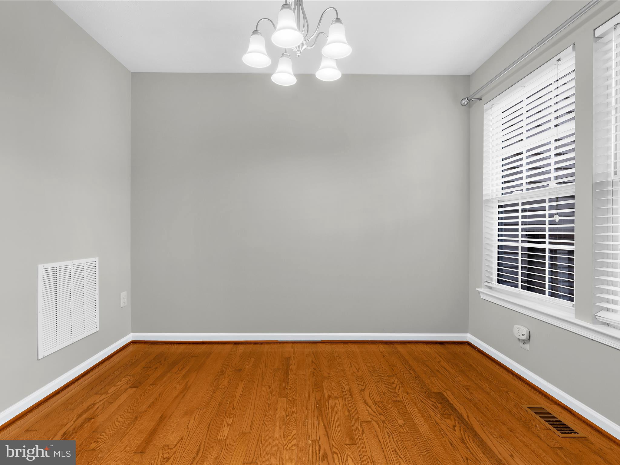 9865 Decatur Road Middle River, MD 21220 - Photo 10 of 63 a view of an empty room with wooden floor and a window