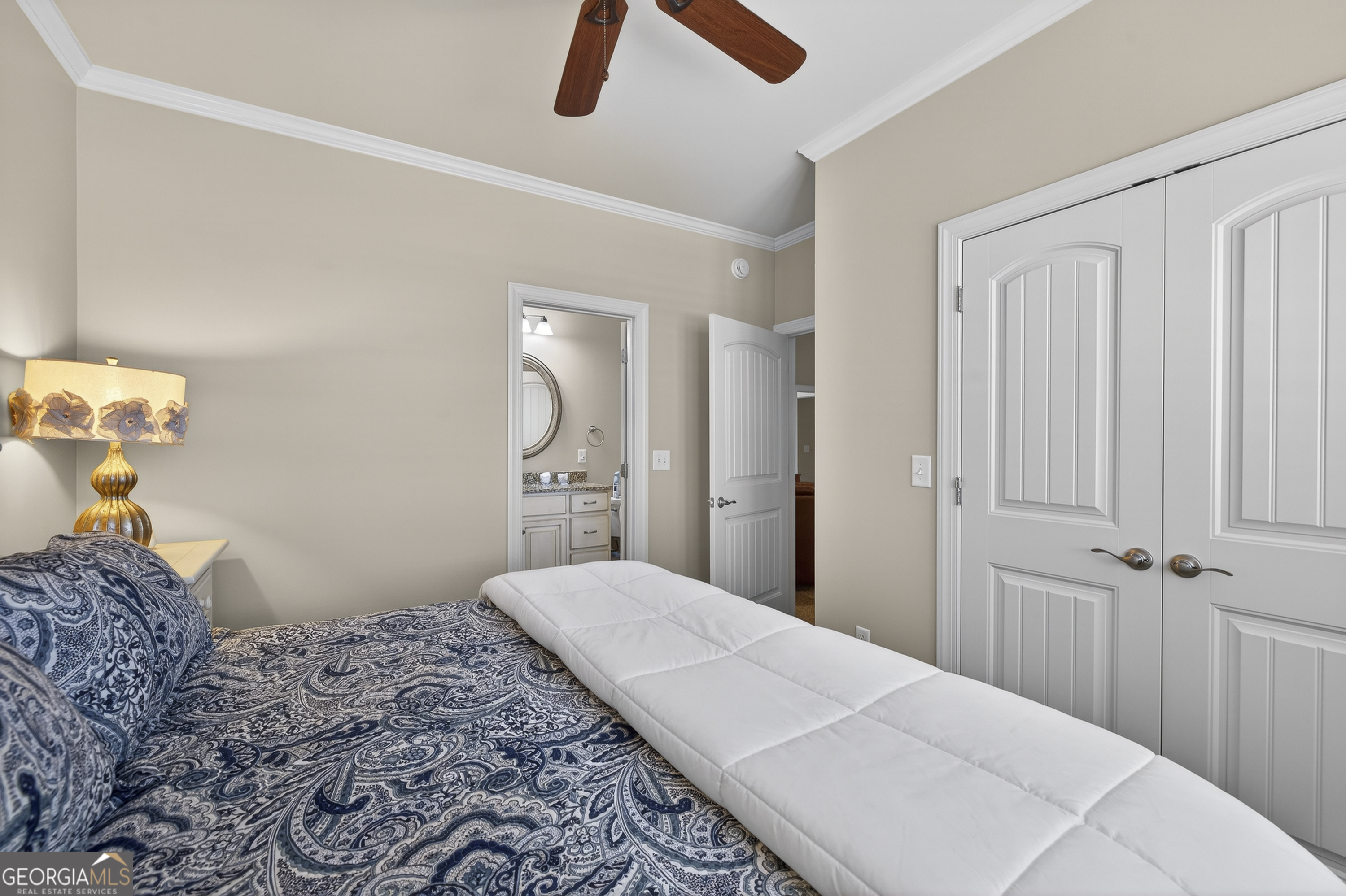 238 Cold Branch Road Eatonton, GA 31024 - Photo 45 of 104 a bedroom with a bed and a chandelier