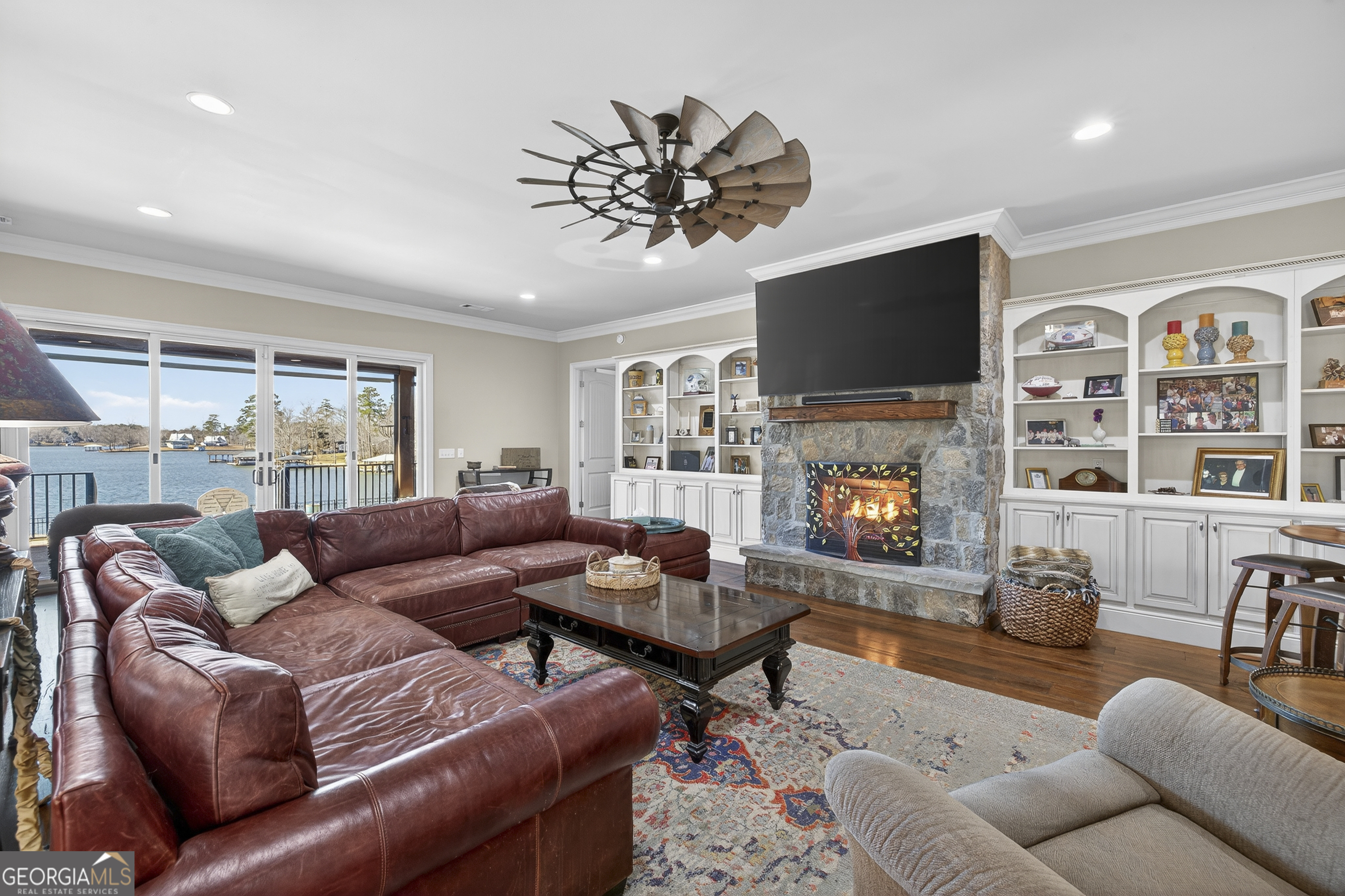 238 Cold Branch Road Eatonton, GA 31024 - Photo 5 of 104 a living room with furniture a flat screen tv and a fireplace