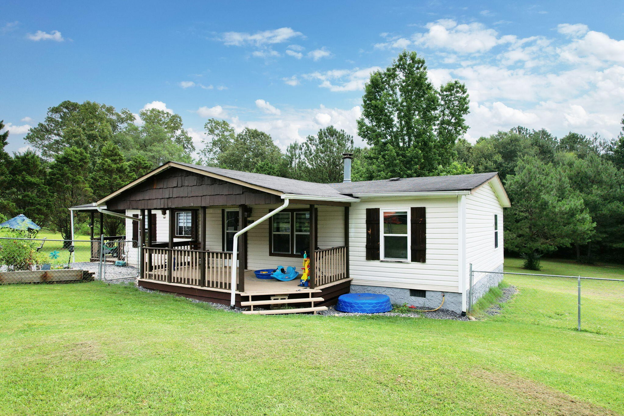 2131 Southeast Hunt Road Cleveland, TN 37323 - Photo 1 of 38 a view of a house with a backyard and a patio