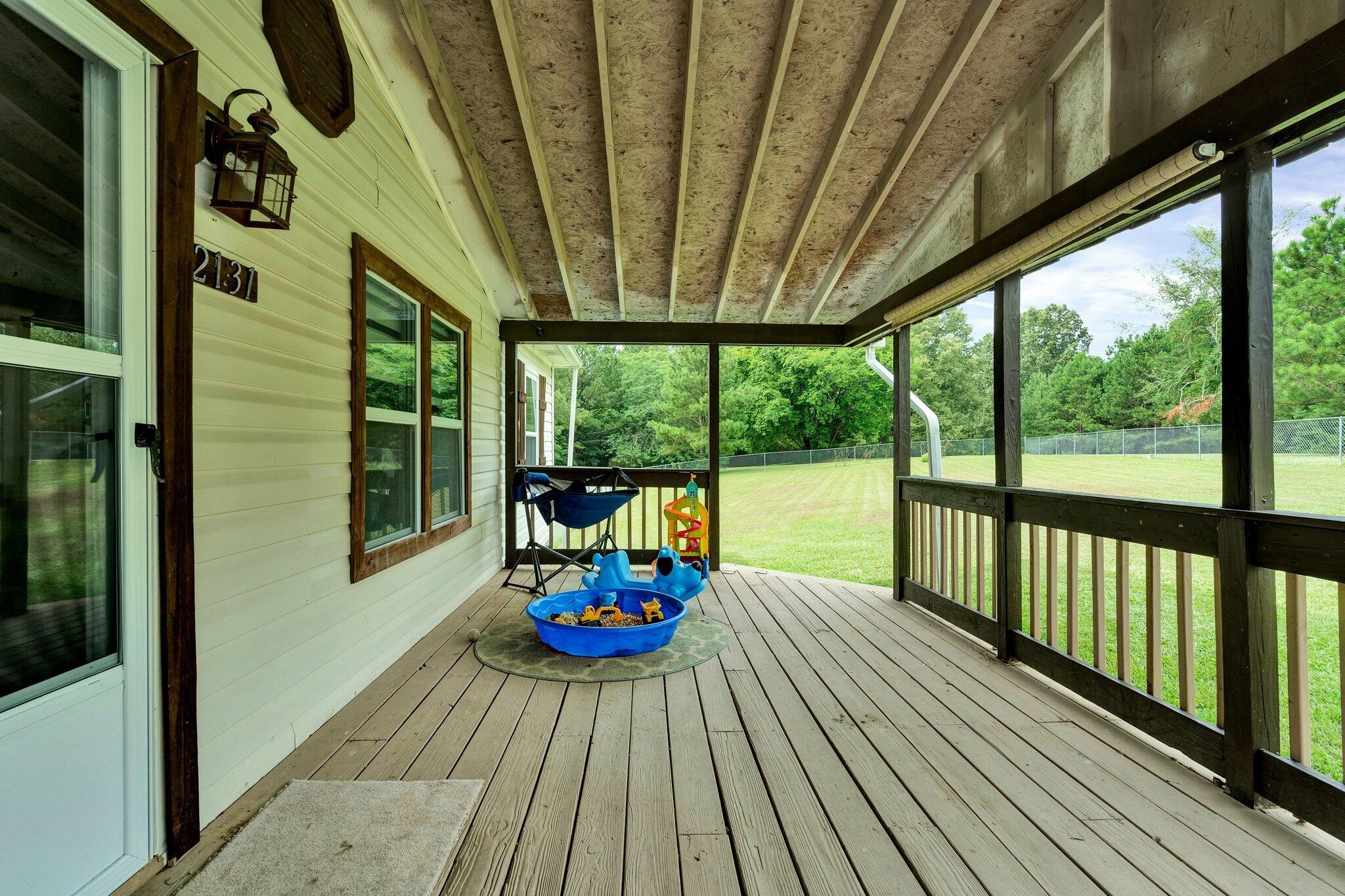 2131 Southeast Hunt Road Cleveland, TN 37323 - Photo 23 of 38 a balcony with chairs and wooden floor