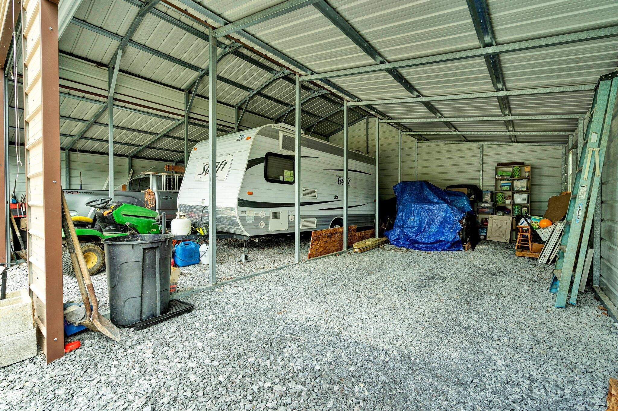 2131 Southeast Hunt Road Cleveland, TN 37323 - Photo 28 of 38 a view of a garage with a table and chairs and potted plants